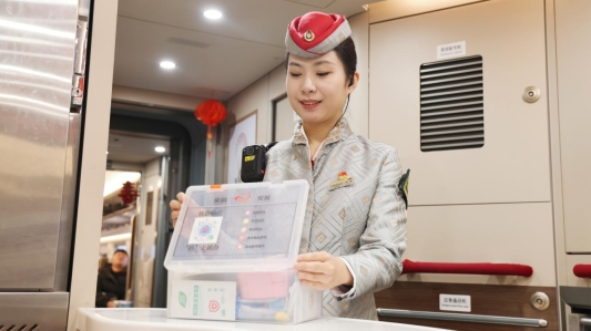 G75次列车长李雪检查应急便民服务箱(陈琳摄)