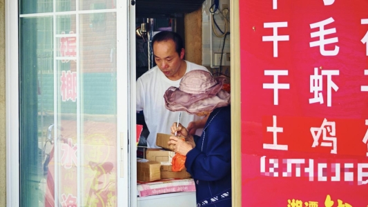 图为宋擒良为客户收发快递