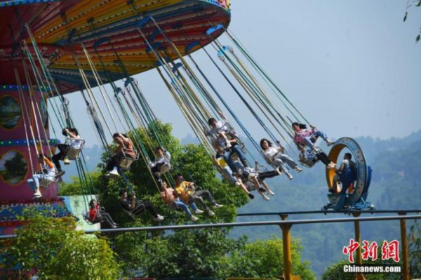 5月1日，“五一”节假的第一天， 重庆涪陵红酒小镇景区内的游客乘坐体验游乐设施。　<a target='_blank' href='http://www.chinanews.com/' _fcksavedurl='http://www.chinanews.com/'></p><p  align=