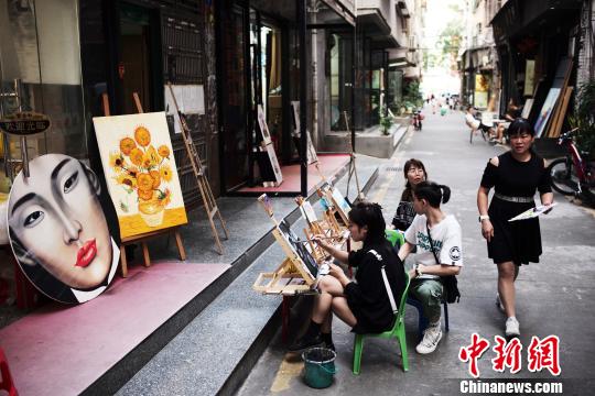 图为游客在深圳大芬村体验作画。　陈文 摄