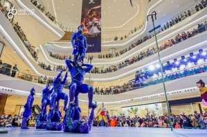 A group of people in blue clothing in a large building

Description automatically generated