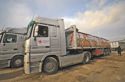 12月17日,载有中国援助的人道主义物资的货车抵达凯雷姆沙洛姆口岸加沙地带一侧。亚西尔·库迪摄(新华社发) 12月17日,载有中国援助的人道主义物资的货车抵达凯雷姆沙洛姆口岸加沙地带一侧。亚西尔·库迪摄(新华社发)